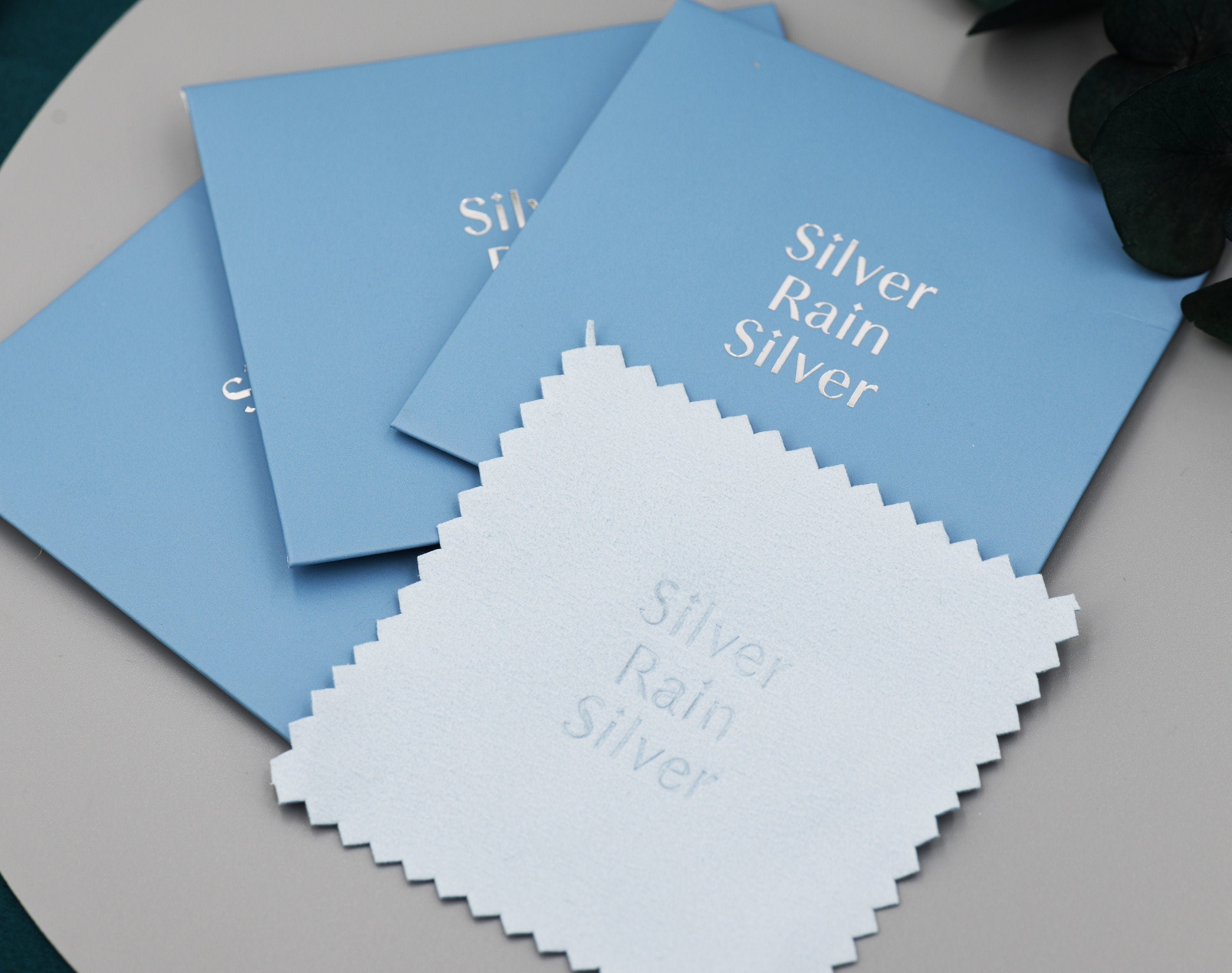 Detailed view of 'Silver Rain Silver' branded silver polishing cloth. 