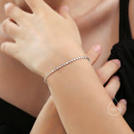 May include: A silver bracelet with a delicate chain made of small, round links.
