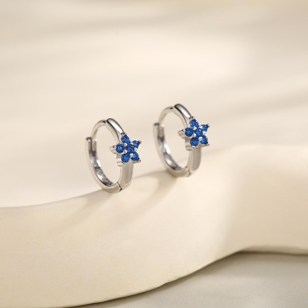 Tiny Sapphire Blue CZ Flower Huggie Hoops, CZ Hoop Earrings, Crystal Flower Huggie Earrings, September Birthstone